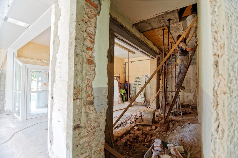 Room mid-renovation with exposed framing and construction debris